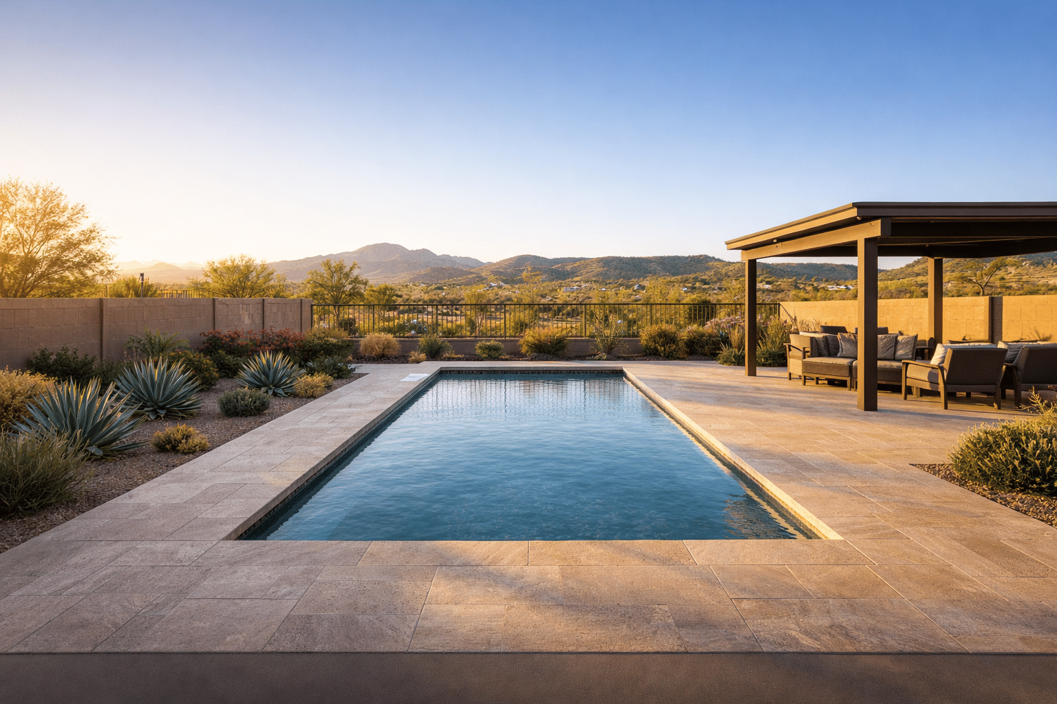 Resort-style backyard with pool, travertine decking, and desert landscaping in a Florence, Arizona home — West USA Realty