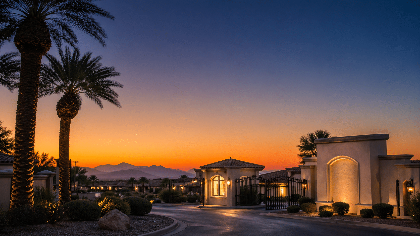 West Valley Arizona 55+ community entry monument and gate at twilight on a clear winter evening