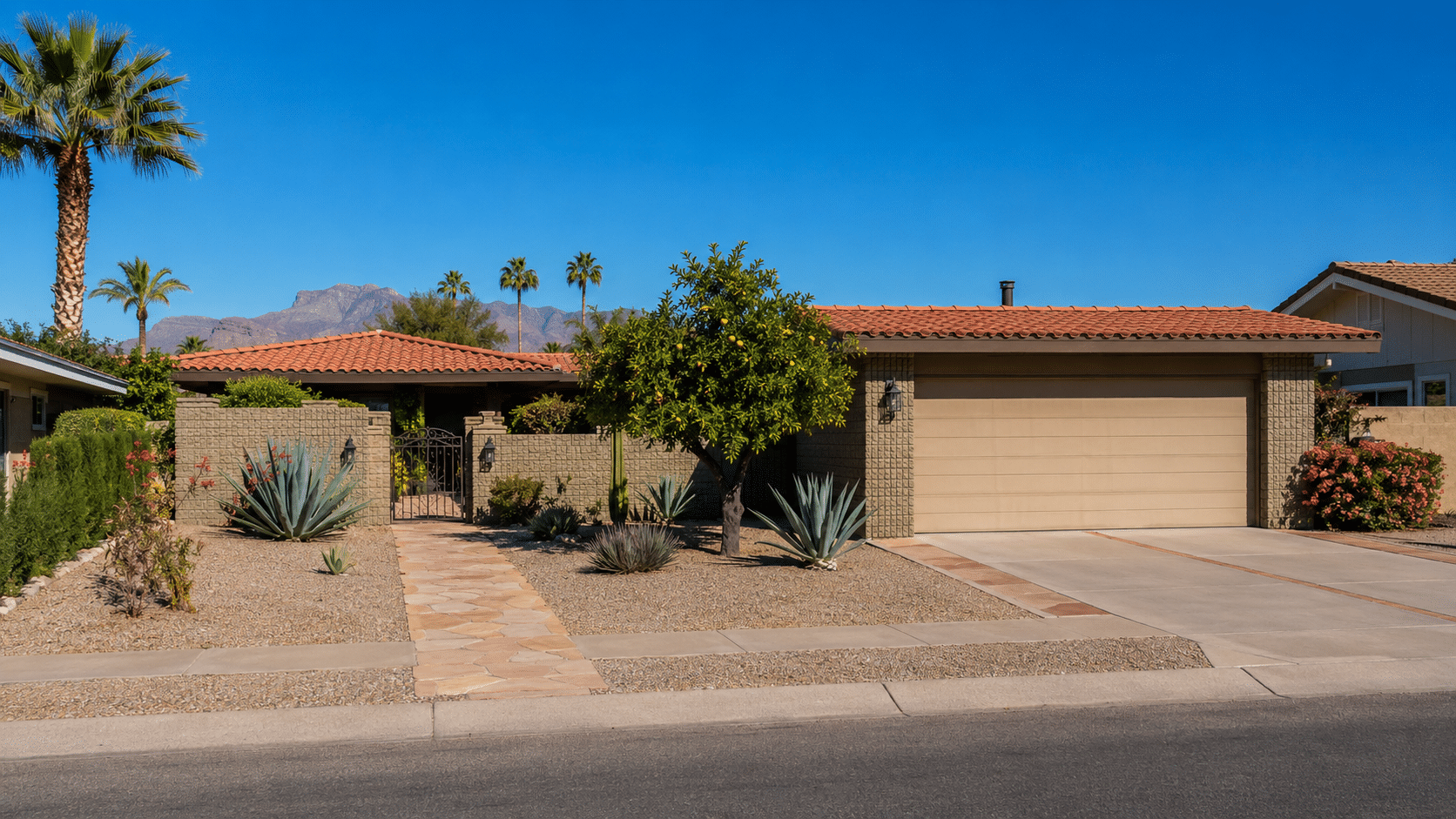 Mesa Real Estate exterior of a renovated Sunland Village single-family home with desert landscaping and two-car garage - West Usa Realty