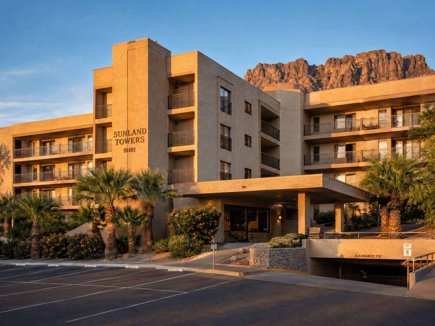 Mesa Real Estate exterior of Sunland Towers condos at Sunland Village with balconies and mountain backdrop - West Usa Realty