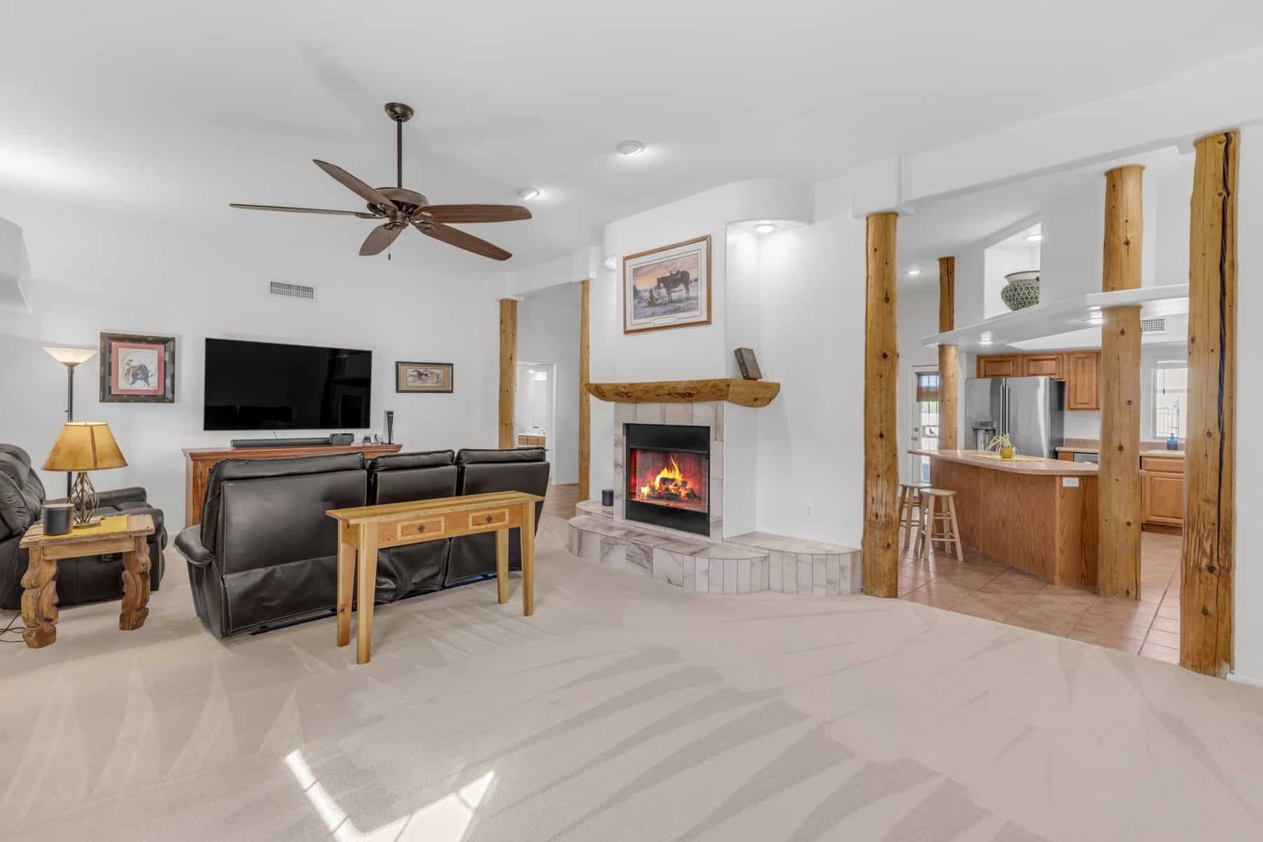 Family room with new carpet, vaulted ceiling and the see-through wood-burning fireplace