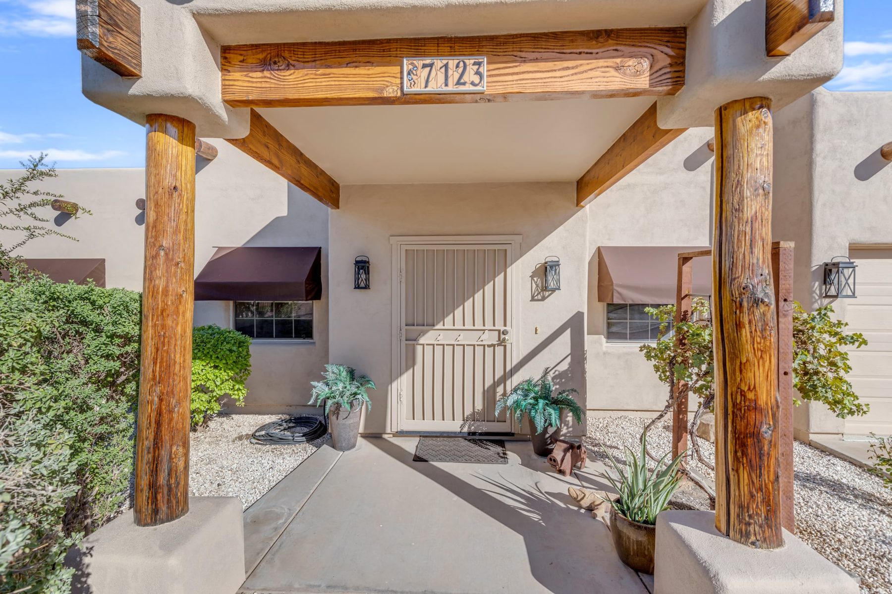 Covered front entry with log posts and security door