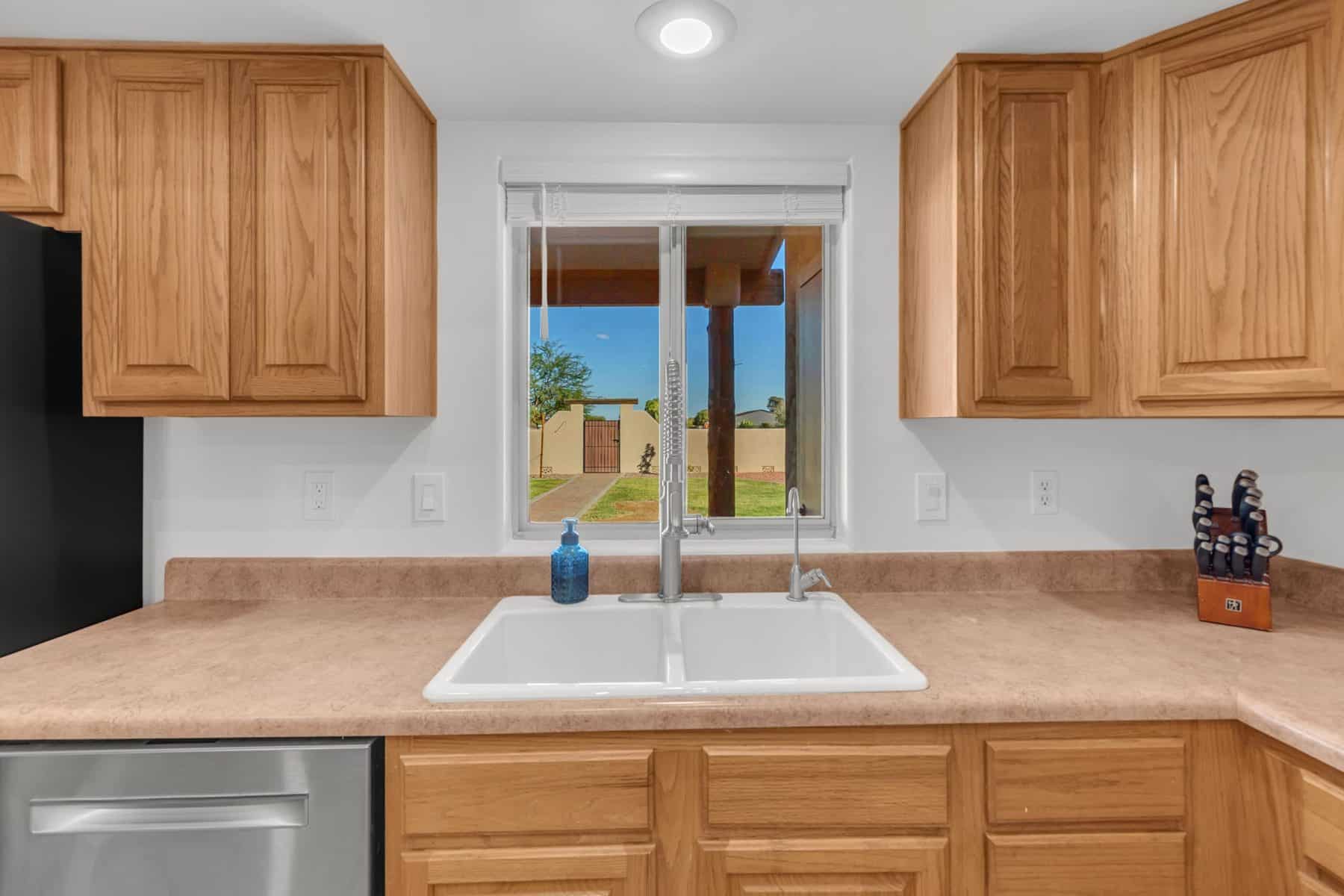 Kitchen sink with a window to the backyard