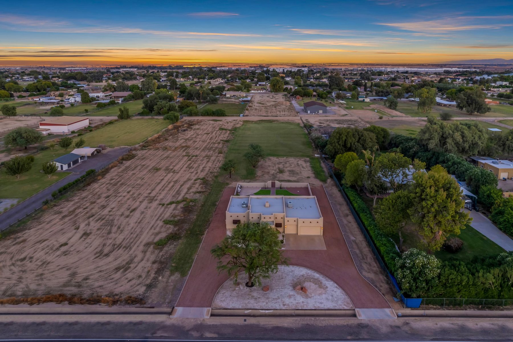 Aerial view of the full lot with the house in front and pasture behind